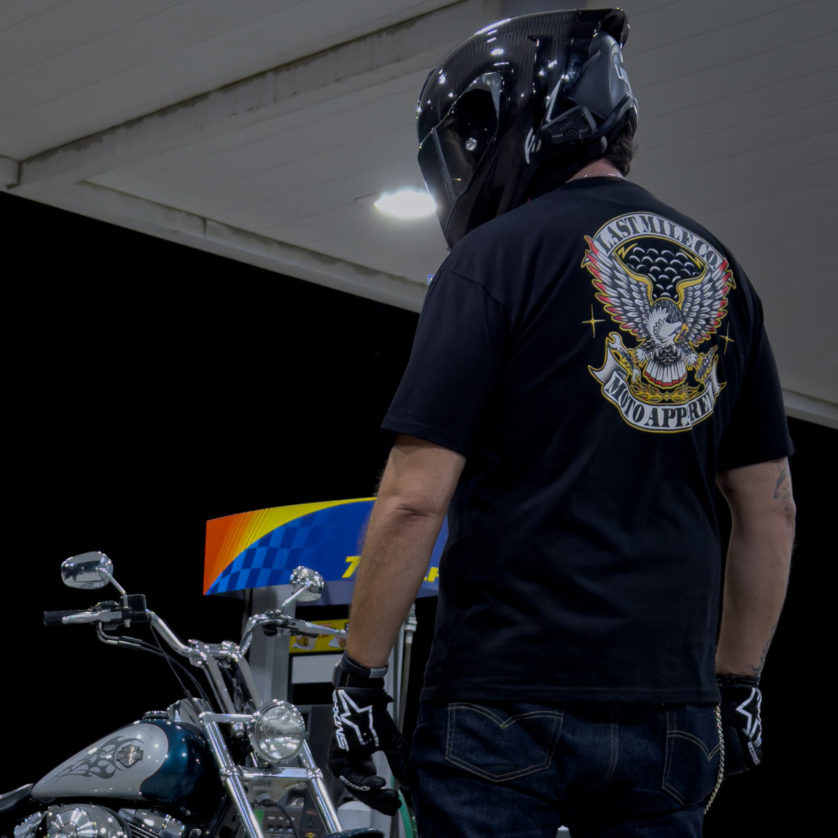 Grease and Gold Tee men's motorcycle t-shirt worn at a gas station at night, full colour eagle back print