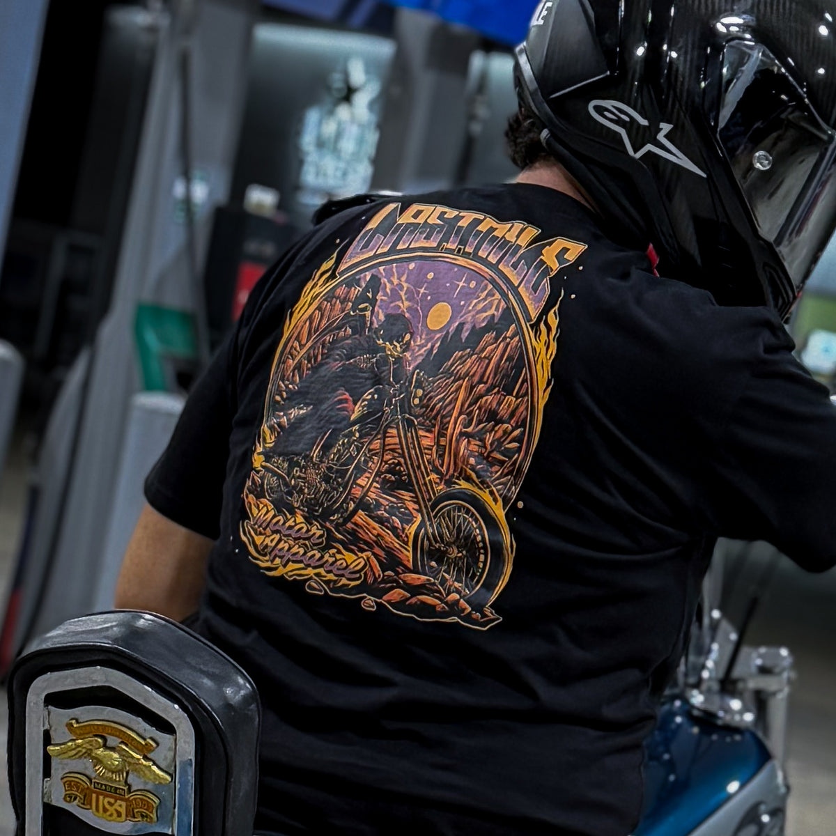 Last Rites Tee men's motorcycle t-shirt back print shown on a rider beside a Harley Dyna at night