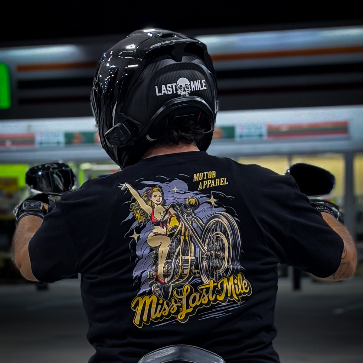 Miss Last Mile Tee men's motorcycle t-shirt worn on a motorcycle at night, pin-up on a chopper back print